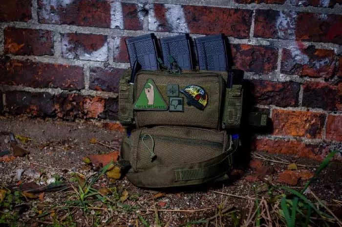 four magazines hidden in a green military rucksack with patches