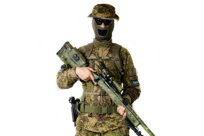 airsoft player is dressed in uniform and holding an airsoft sniper rifle