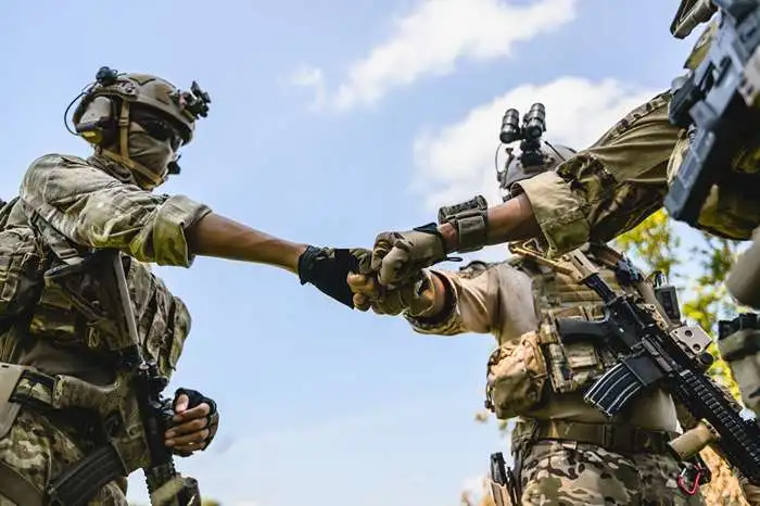 squad of airsoft players stacking hands